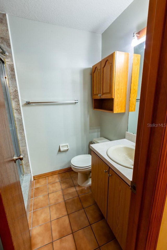 3267 Villa Way Cir, Saint Cloud, FL 34769 - bathroom featuring vanity, tile patterned floors, a textured ceiling, and a shower
