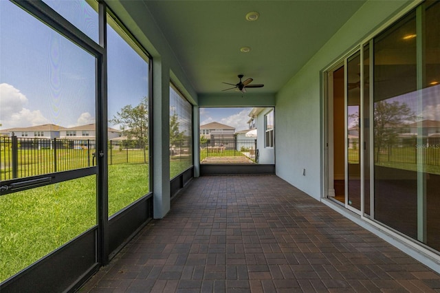 5648 Cedar Chase Dr, Saint Cloud, FL 34771 - unfurnished sunroom featuring a ceiling fan and a residential view