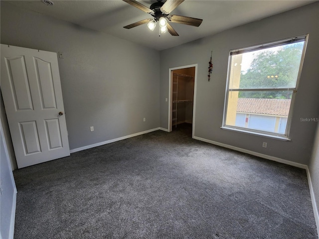 1325 Lake Shadow Cir Unit 12205, Maitland, FL 32751 - unfurnished bedroom with dark carpet, a walk in closet, baseboards, and a closet