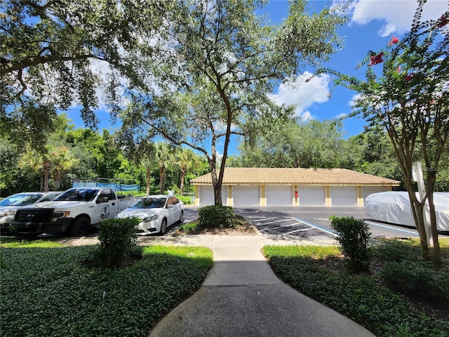 1325 Lake Shadow Cir Unit 12205, Maitland, FL 32751 - view of front of house with community garages, a tiled roof, and stucco siding