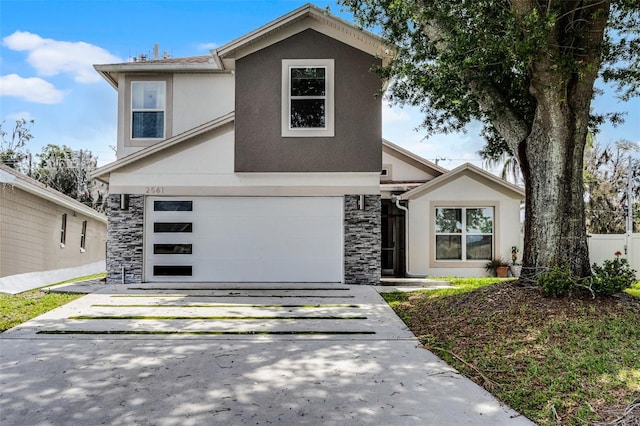 2561 Montego Bay Blvd, Kissimmee, FL 34746 - traditional-style home with stone siding, driveway, stucco siding, and an attached garage