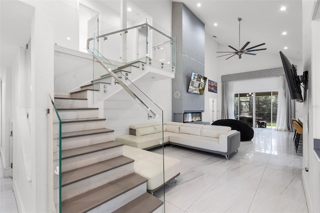 2561 Montego Bay Blvd, Kissimmee, FL 34746 - living area featuring high vaulted ceiling, ceiling fan, light marble finish flooring, a large fireplace, and recessed lighting