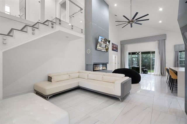 2561 Montego Bay Blvd, Kissimmee, FL 34746 - living area featuring high vaulted ceiling, a fireplace, ceiling fan, light marble finish flooring, and recessed lighting