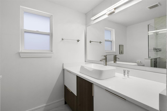 2561 Montego Bay Blvd, Kissimmee, FL 34746 - bathroom featuring vanity, a stall shower, and baseboards