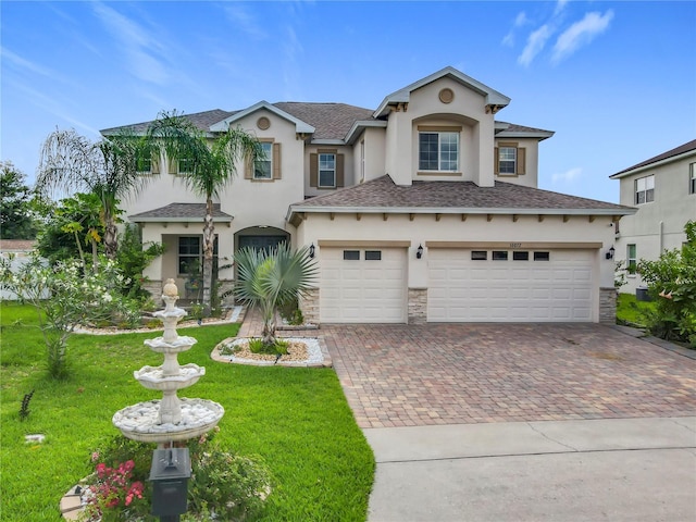 16072 Shasta St, Clermont, FL 34714 - view of front of house with stucco siding, decorative driveway, a garage, and a front yard