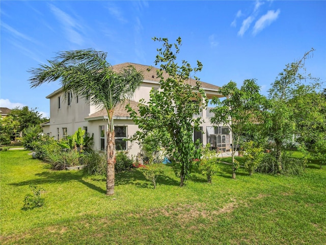 16072 Shasta St, Clermont, FL 34714 - rear view of house featuring stucco siding and a yard