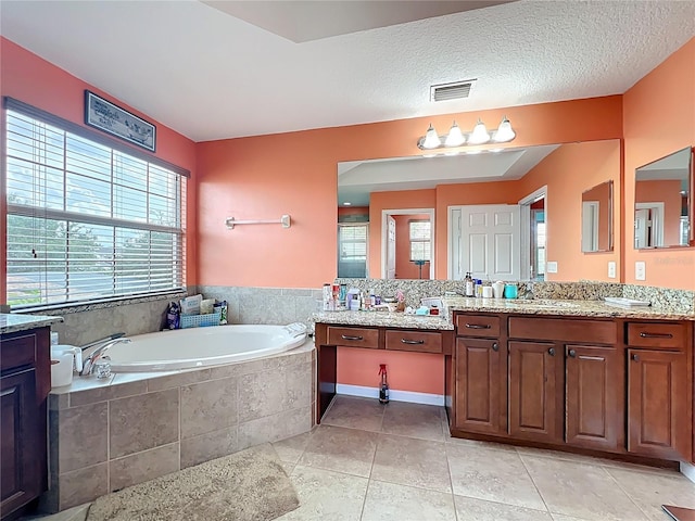 16072 Shasta St, Clermont, FL 34714 - bathroom featuring a garden tub, vanity, and tile patterned floors