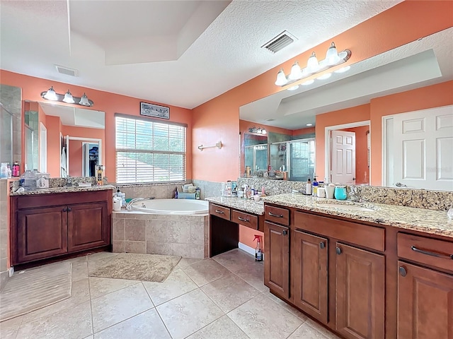 16072 Shasta St, Clermont, FL 34714 - bathroom featuring a stall shower, a bath, two vanities, and tile patterned floors