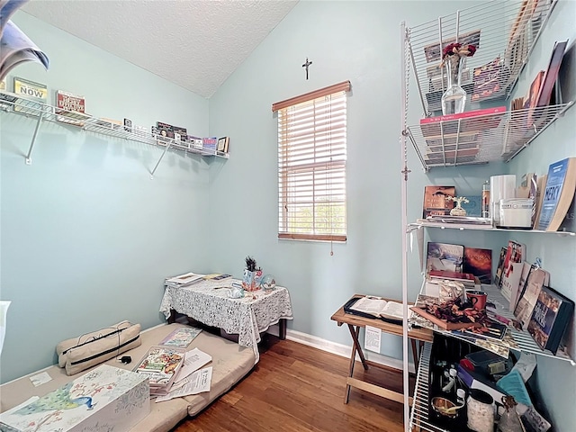 16072 Shasta St, Clermont, FL 34714 - bedroom featuring wood finished floors, lofted ceiling, a textured ceiling, and baseboards