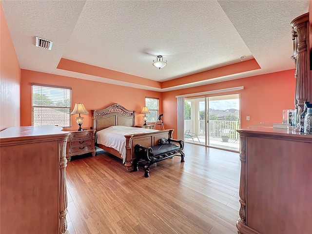 16072 Shasta St, Clermont, FL 34714 - bedroom featuring a raised ceiling, a textured ceiling, access to outside, and multiple windows