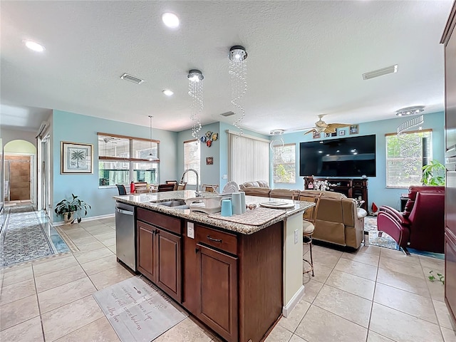 16072 Shasta St, Clermont, FL 34714 - kitchen with a sink, a ceiling fan, a center island with sink, light tile patterned flooring, and open floor plan