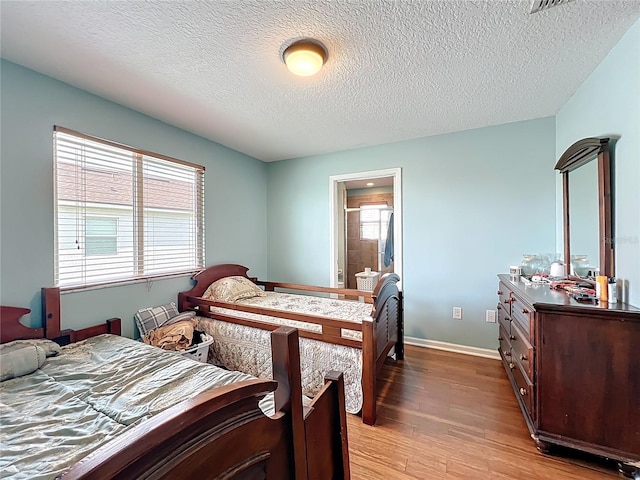 16072 Shasta St, Clermont, FL 34714 - bedroom featuring light wood-style flooring, baseboards, and a textured ceiling