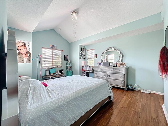 16072 Shasta St, Clermont, FL 34714 - bedroom featuring vaulted ceiling, multiple windows, dark wood-style floors, baseboards, and a textured ceiling