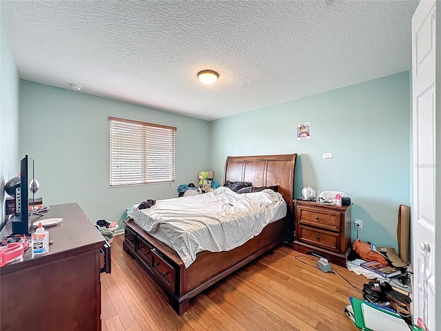 16072 Shasta St, Clermont, FL 34714 - bedroom with light wood-style flooring and a textured ceiling
