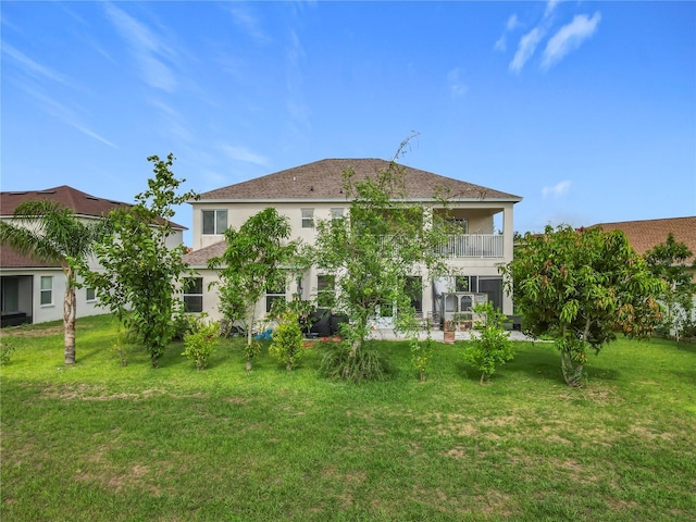 16072 Shasta St, Clermont, FL 34714 - back of property with a balcony, stucco siding, and a lawn