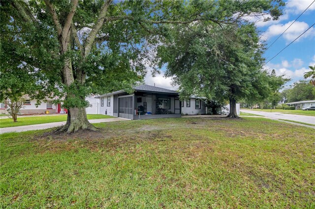 2 S Lavon Ave, Kissimmee, FL 34741 - ranch-style house with a sunroom and a front lawn