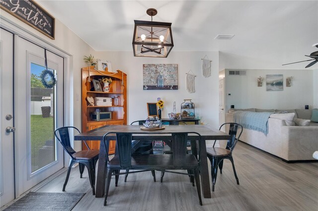 2 S Lavon Ave, Kissimmee, FL 34741 - dining area featuring wood finished floors, a chandelier, and a ceiling fan