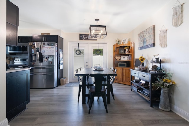 2 S Lavon Ave, Kissimmee, FL 34741 - dining area with a chandelier, wood finished floors, french doors, and baseboards