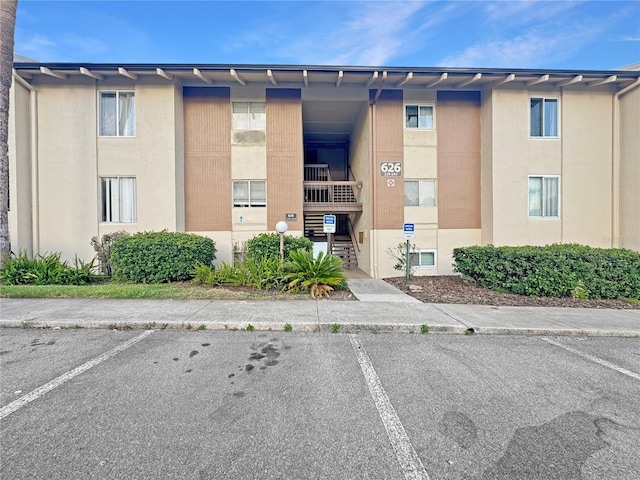 626 Orange Dr Unit 243, Altamonte Springs, FL 32701 - view of building exterior with uncovered parking and stairway