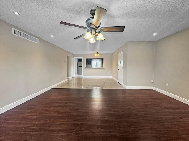 626 Orange Dr Unit 243, Altamonte Springs, FL 32701 - unfurnished living room with wood finished floors, a textured ceiling, baseboards, ceiling fan, and recessed lighting