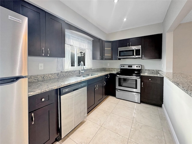 626 Orange Dr Unit 243, Altamonte Springs, FL 32701 - kitchen with appliances with stainless steel finishes, a sink, light stone countertops, light tile patterned floors, and recessed lighting