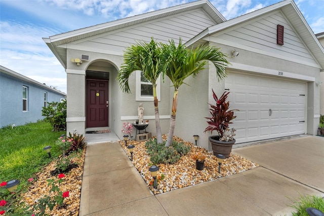 2838 Common Crane Ct, Harmony, FL 34773 - view of front of home with a garage, driveway, and stucco siding