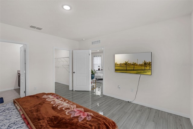 2838 Common Crane Ct, Harmony, FL 34773 - bedroom featuring a spacious closet, baseboards, light wood-style flooring, and a closet