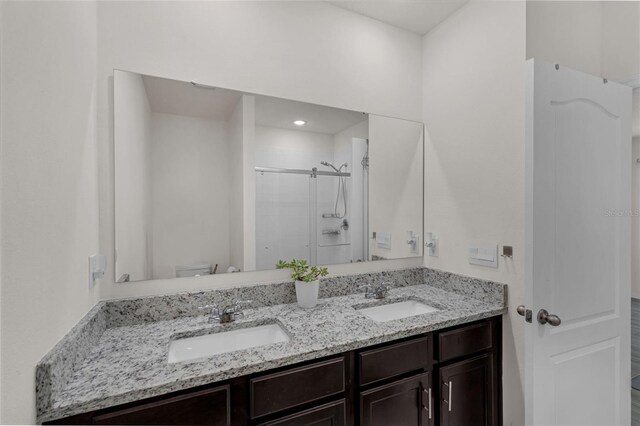 2838 Common Crane Ct, Harmony, FL 34773 - full bathroom with double vanity, a shower stall, and toilet