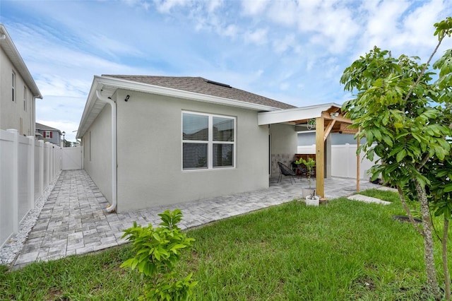 2838 Common Crane Ct, Harmony, FL 34773 - view of property exterior with a patio, stucco siding, and roof with shingles