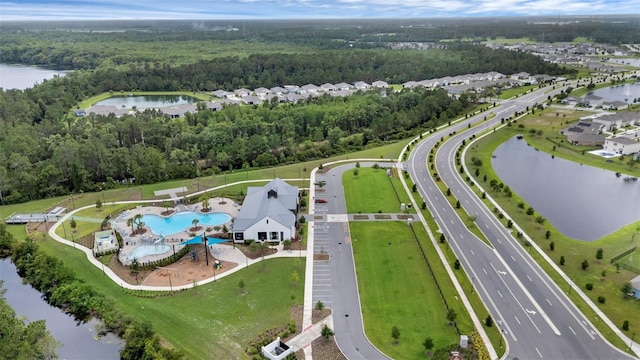 2838 Common Crane Ct, Harmony, FL 34773 - bird's eye view of a nearby body of water, a pool area, and a heavily wooded area