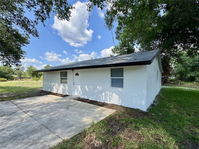 390 Hazel Cir, Punta Gorda, FL 33982 - back of house featuring a patio area, stucco siding, and a yard
