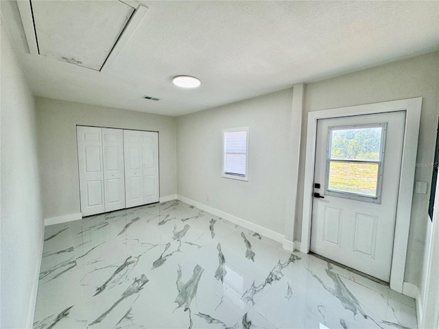 390 Hazel Cir, Punta Gorda, FL 33982 - foyer with baseboards, plenty of natural light, a textured ceiling, and light marble finish floors