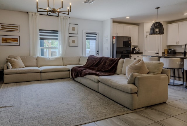 466 Cool Summer Ln, Davenport, FL 33837 - living room featuring a chandelier and recessed lighting