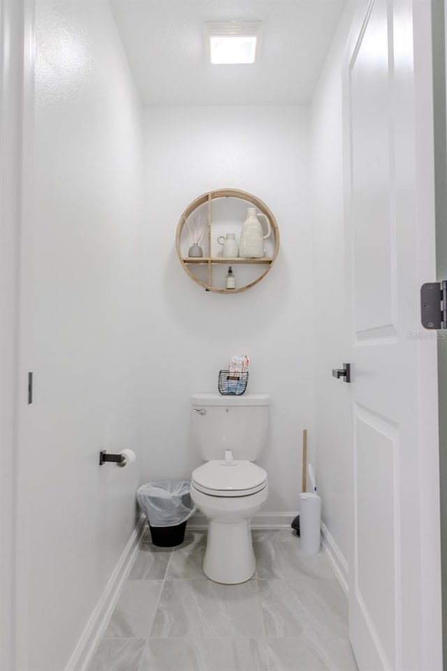 466 Cool Summer Ln, Davenport, FL 33837 - bathroom with toilet, baseboards, and marble finish flooring