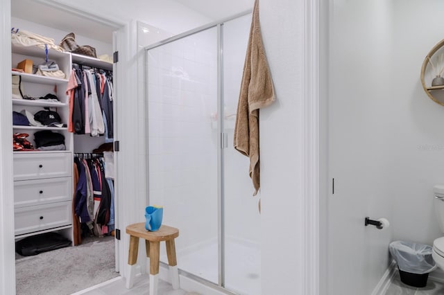 466 Cool Summer Ln, Davenport, FL 33837 - bathroom with toilet, a shower stall, a walk in closet, and baseboards
