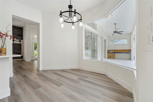 5254 Mill Stream Dr, Saint Cloud, FL 34771 - unfurnished dining area with a ceiling fan, a chandelier, wood finished floors, and plenty of natural light