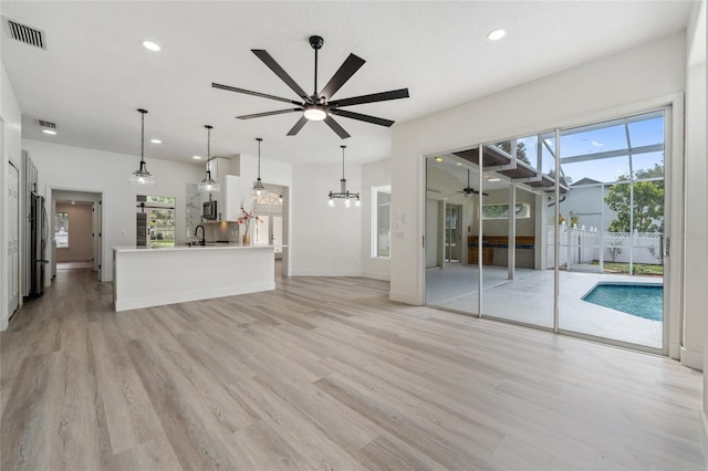 5254 Mill Stream Dr, Saint Cloud, FL 34771 - unfurnished living room with a ceiling fan, recessed lighting, light wood-style flooring, a sink, and baseboards