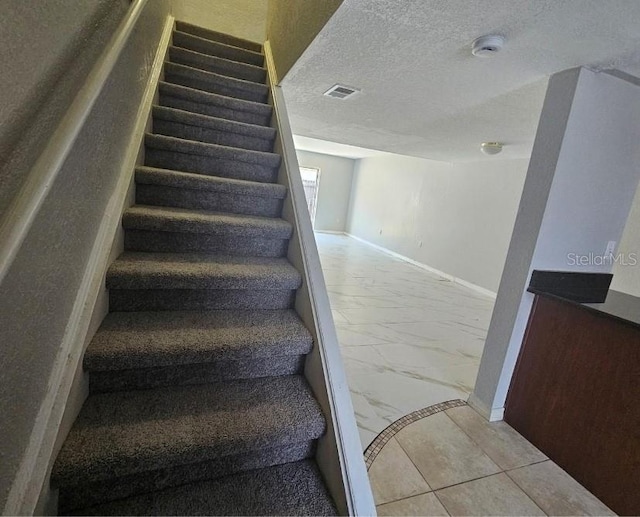 1920 Conway Rd Unit 4, Orlando, FL 32812 - stairway with marble finish floors, baseboards, and a textured ceiling