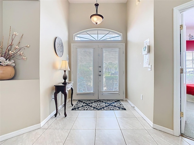 116 Westport Ln, Davenport, FL 33896 - tiled entryway featuring plenty of natural light, a towering ceiling, baseboards, and french doors