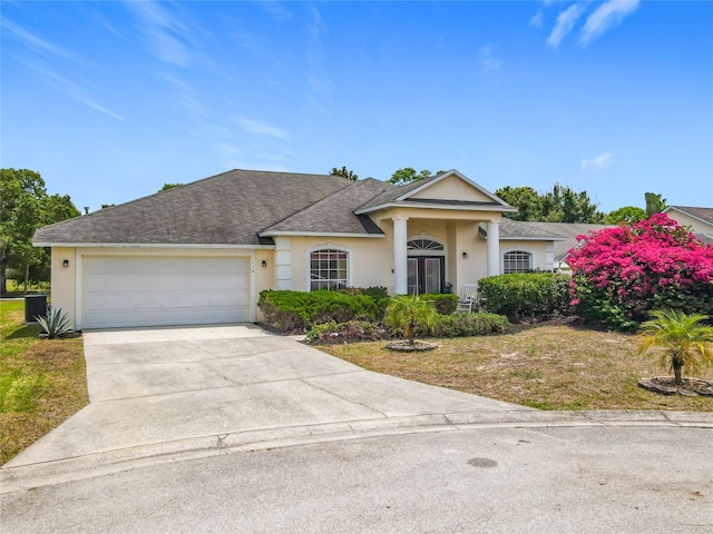116 Westport Ln, Davenport, FL 33896 - view of front facade featuring stucco siding, concrete driveway, a garage, and a shingled roof