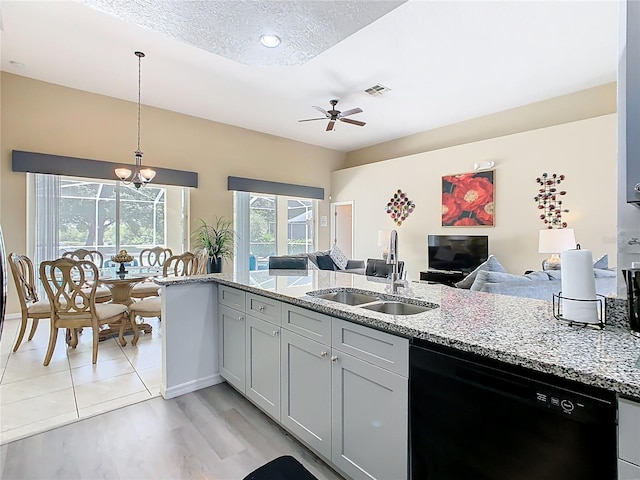 116 Westport Ln, Davenport, FL 33896 - kitchen with black dishwasher, a sink, a ceiling fan, light stone counters, and decorative light fixtures
