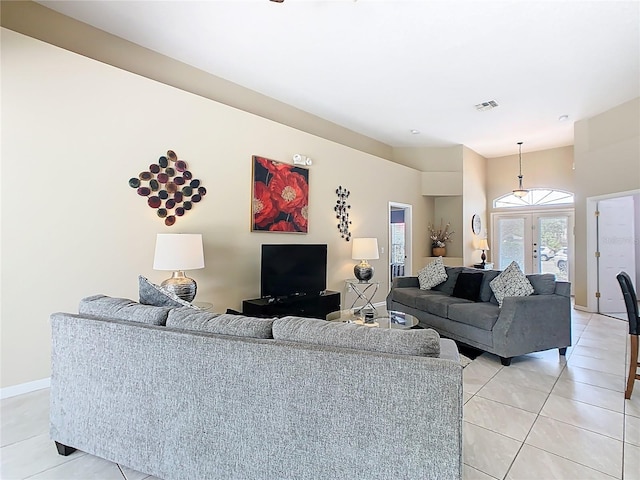 116 Westport Ln, Davenport, FL 33896 - living room featuring light tile patterned floors and baseboards