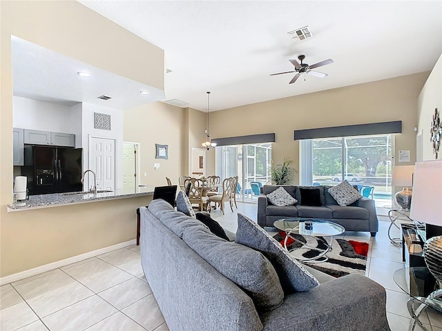 116 Westport Ln, Davenport, FL 33896 - living room with light tile patterned flooring, a ceiling fan, and baseboards