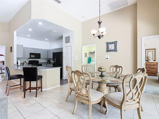 116 Westport Ln, Davenport, FL 33896 - dining area with a high ceiling, light tile patterned floors, and a chandelier