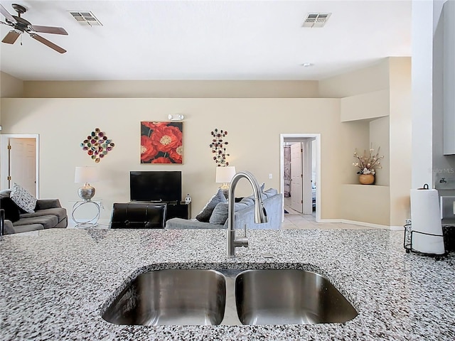 116 Westport Ln, Davenport, FL 33896 - kitchen featuring a sink, open floor plan, light stone countertops, ceiling fan, and tile patterned floors