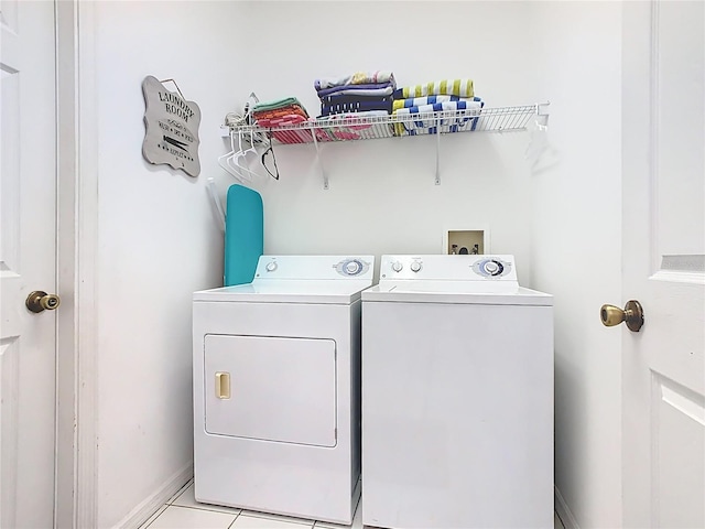 116 Westport Ln, Davenport, FL 33896 - laundry room with separate washer and dryer, light tile patterned floors, and baseboards
