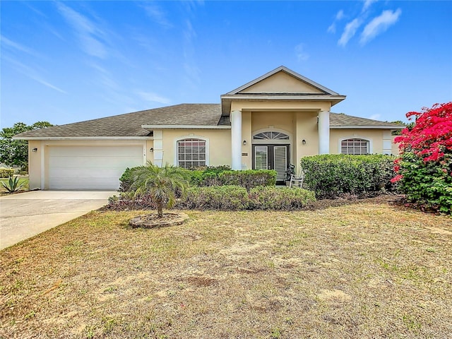116 Westport Ln, Davenport, FL 33896 - view of front of home with stucco siding, an attached garage, concrete driveway, a front lawn, and roof with shingles
