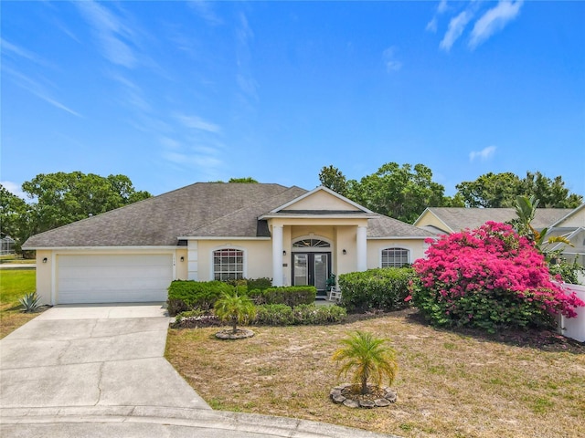 116 Westport Ln, Davenport, FL 33896 - view of front of house with stucco siding, a garage, concrete driveway, a shingled roof, and a front lawn