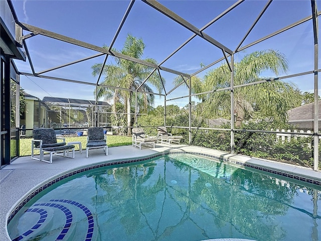 107 Amaca Ln, Davenport, FL 33897 - swimming pool with a patio area and glass enclosure