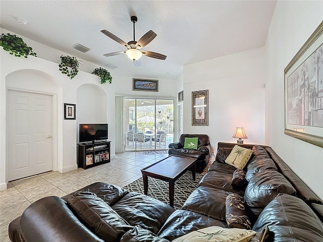 107 Amaca Ln, Davenport, FL 33897 - living area with a ceiling fan, light tile patterned flooring, arched walkways, and a textured ceiling